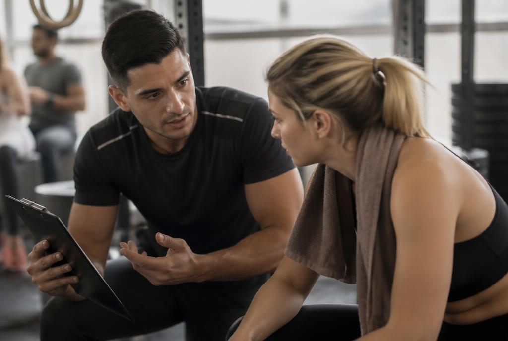 Coach reviewing progress with a client after a workout